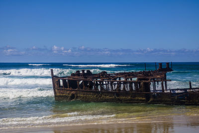 Photograph of the shipwreck of the ss maheno on fraser island with a cloudless sky in the background
