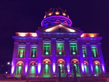 Low angle view of illuminated building at night