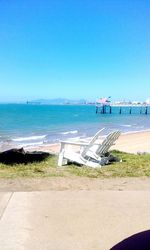 Scenic view of beach against clear blue sky