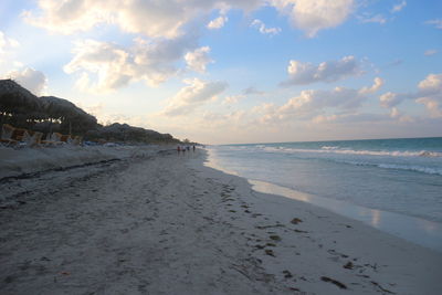 Scenic view of beach against sky during sunset