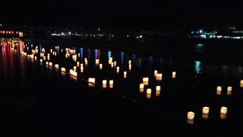 Reflection of illuminated river in city at night