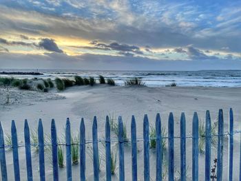 Scenic view of beach against sky during sunset