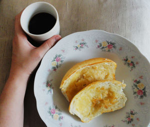 Cropped hand of person having breakfast at home