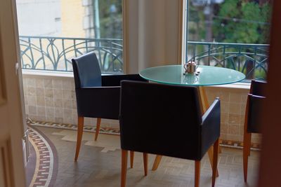 Tables and chairs arranged in room