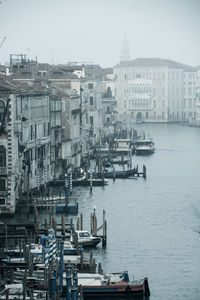 Boats in sea against buildings in city