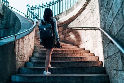 Rear view of woman walking on staircase