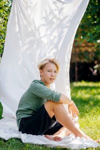 Portrait of young woman sitting in tent