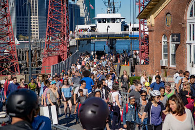 Crowd at harbor during sunny day