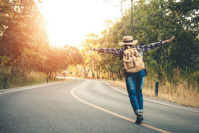 Rear view of man standing on road