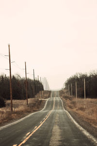 Empty road along trees