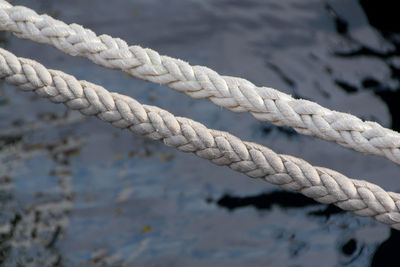 Close-up of ropes over lake