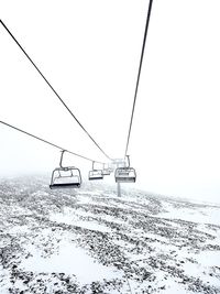 Overhead cable car against sky during winter