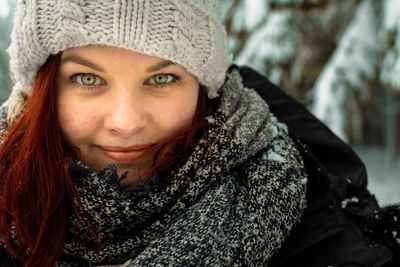 Portrait of smiling young woman in snow