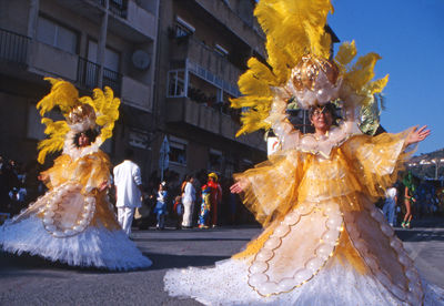 People dancing on street in city