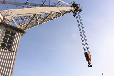 Low angle view of crane against sky