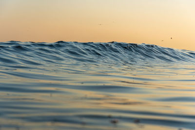 Scenic view of sea against clear sky during sunset