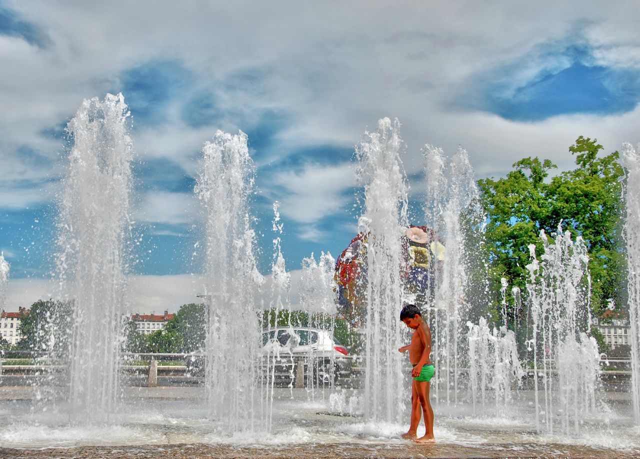 water, motion, splashing, spraying, fountain, leisure activity, lifestyles, long exposure, enjoyment, waterfall, waterfront, men, full length, sky, fun, blurred motion, flowing water, standing