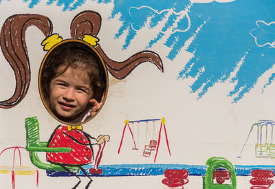 Full length of cute baby girl against graffiti wall