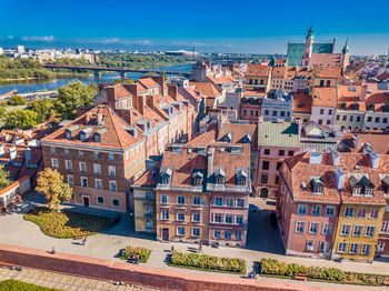 Beautiful colorful hdr aerial image of the famous old town in warsaw, poland. on blue dramatic sky