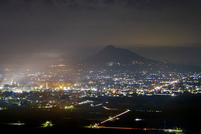 High angle view of illuminated buildings in city at night