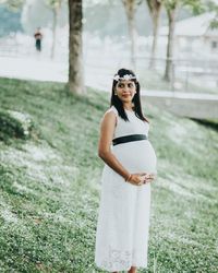 Young woman standing on grass