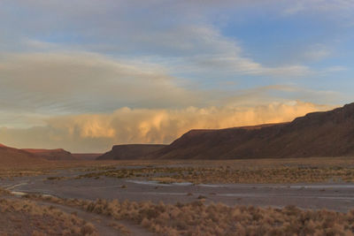 Scenic view of desert against sky during sunset