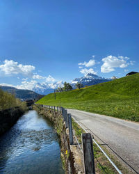 Scenic view of landscape against blue sky