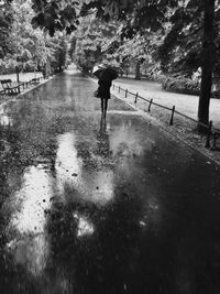 Full length of woman walking on footpath