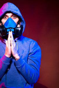 Midsection of man wearing mask against white background