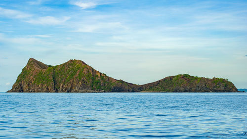 Scenic view of sea and mountains against sky