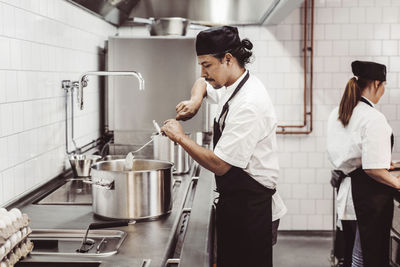 Chefs preparing food in commercial kitchen