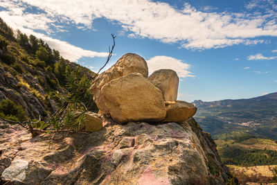 Rock formation on mountain against sky