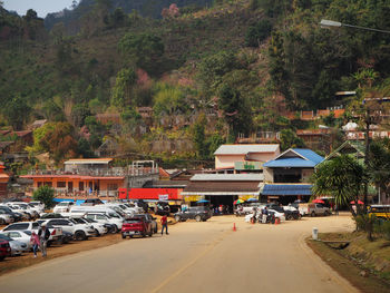 Cars on street by buildings in city