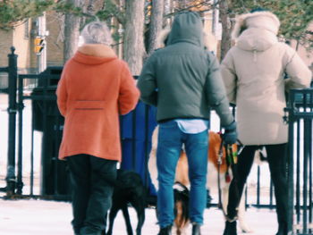 Rear view of people walking on street