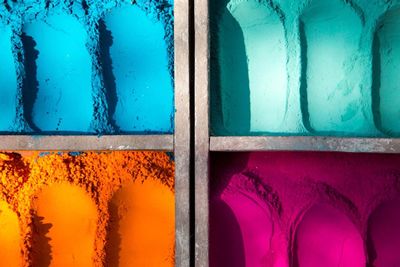 Directly above shot of multi colored powder paint in wooden containers