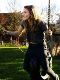 Young woman on swing in playground