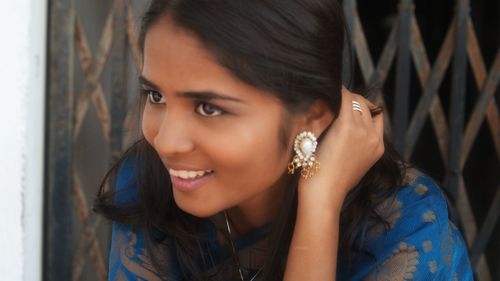 Close-up portrait of smiling young woman