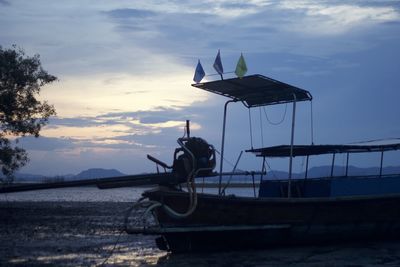 Ship moored at sea shore against sky