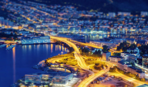 High angle view of city lit up at night