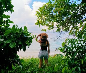 Young woman amidst plants