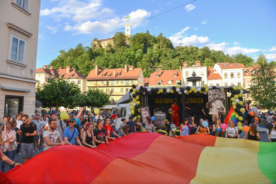 People on street in city against sky