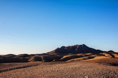 Scenic view of mountain against blue sky