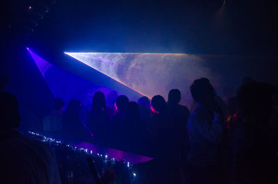 Light beams falling on people in nightclub