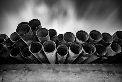 Low angle view of old pipes against sky