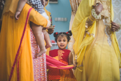 Rear view of girls standing in corridor