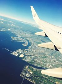 Cropped image of airplane flying over landscape