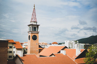 Tower amidst buildings against sky in city