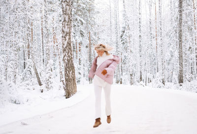 Full length of woman standing in snow