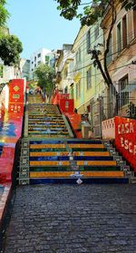 Staircase leading towards city against sky