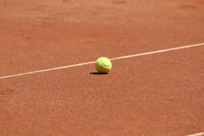 Close-up of tennis ball on playing field